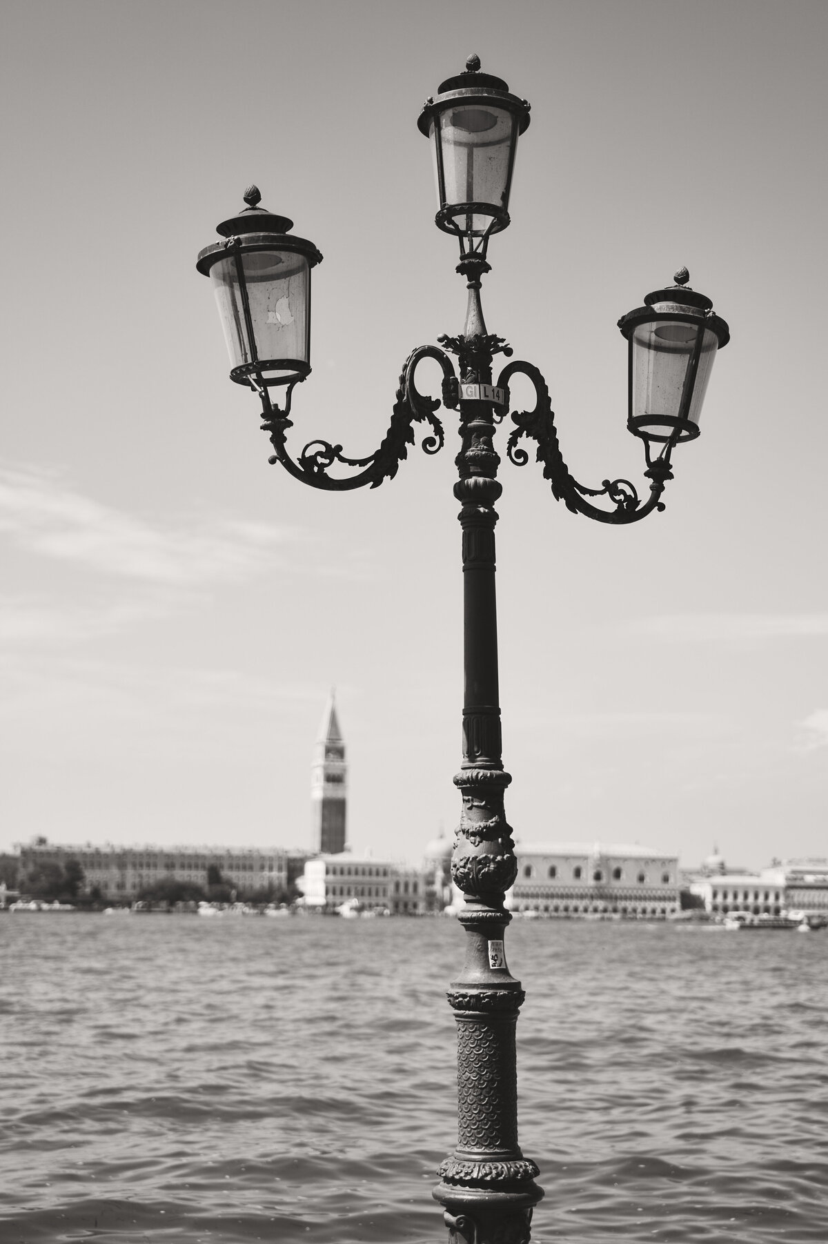 A lamp post in front of water in Venice