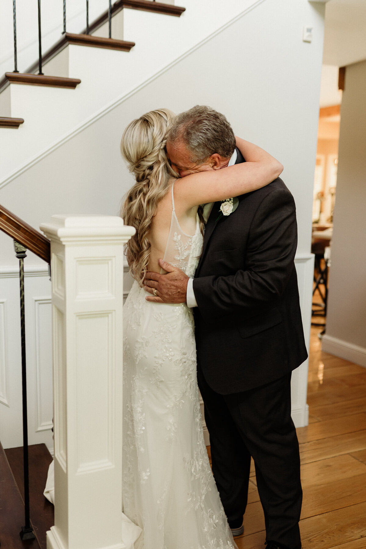 father of the bride hugs his daughter during first look