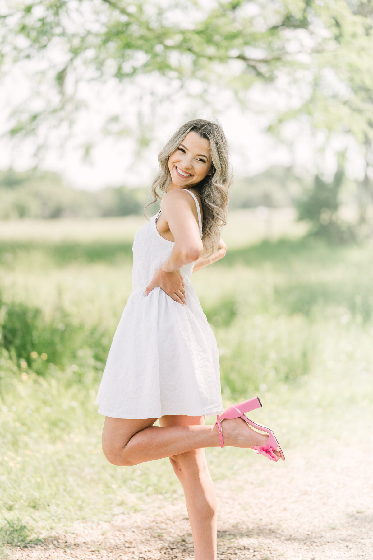 Pink heel kicks back to show off shoes in a Baton Rouge senior session.