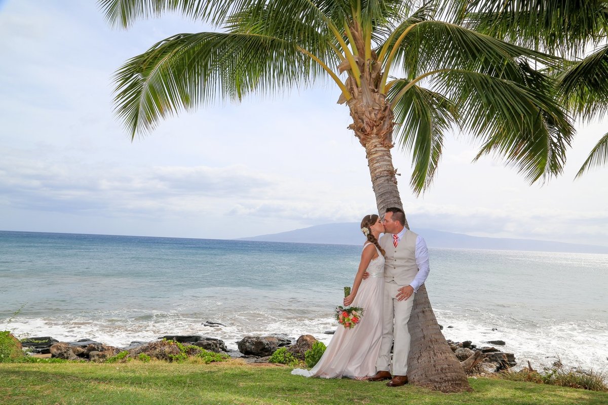 Capture Aloha Photography at The Westin Maui Resort and Spa With Kissing Bride and Groom at beach and coconut tree