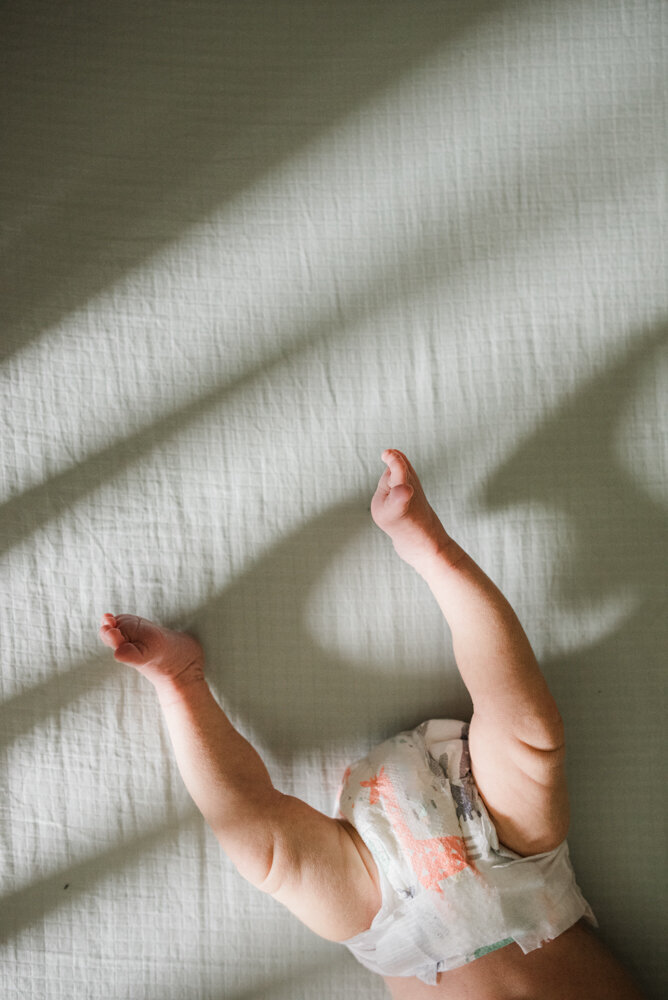 Baby feet in crib, simple newborn poses