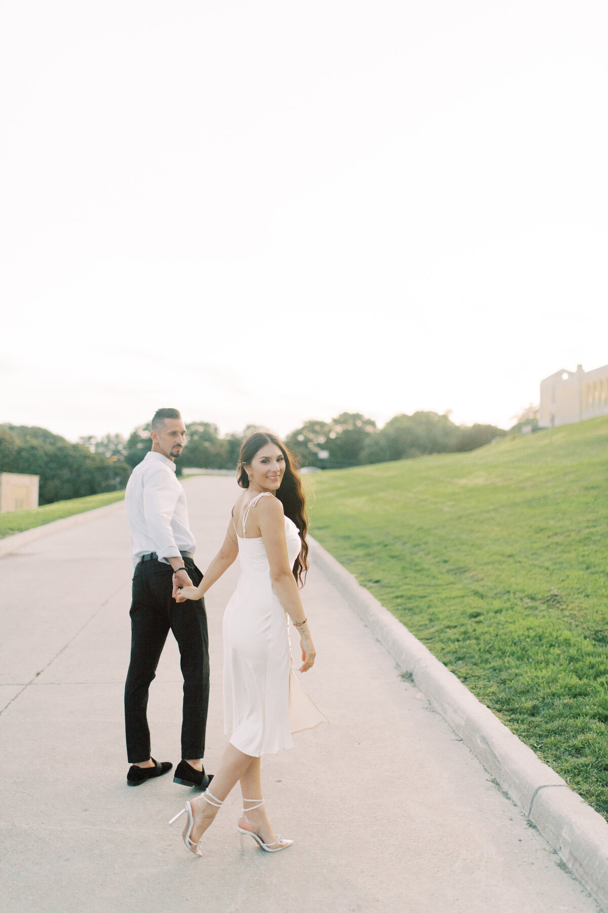 A romantic walk down the stairs of Toronto’s RC  Harris Water Treatment Plant, the couple holding hands, with the groom leading the way