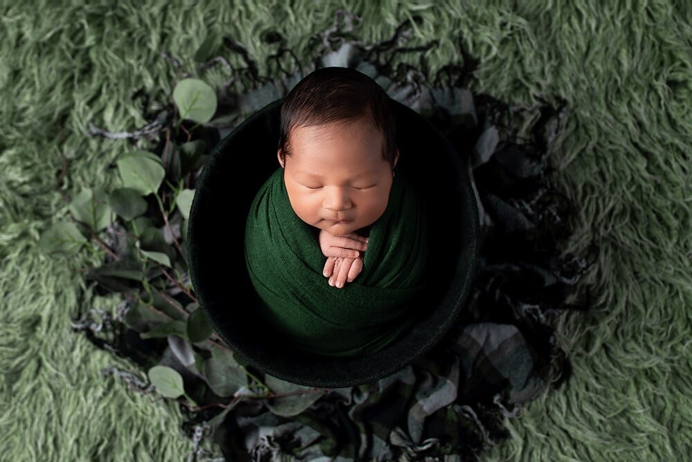 Baby boy in forest green wrapped in bucket prop