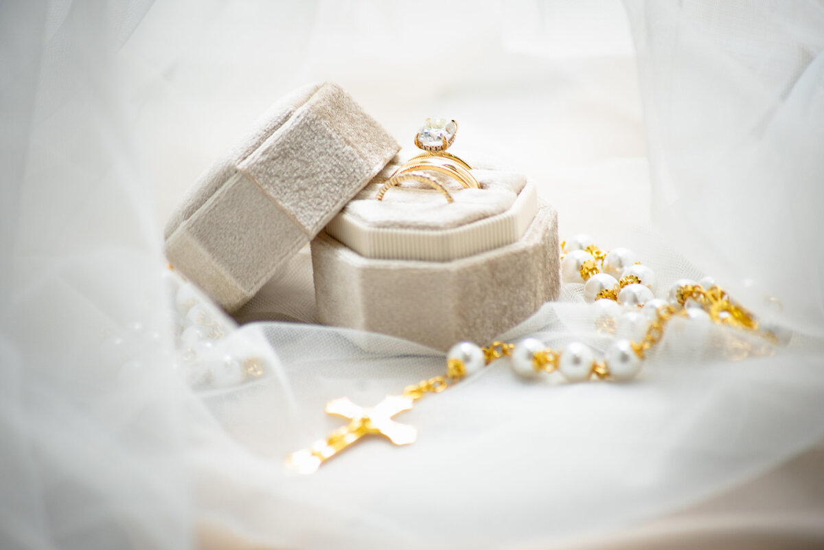 Discover the beauty of the rings and the rosary, capturing the essence of devotion and love in the details at Anais Events Center in Bellaire, Texas.