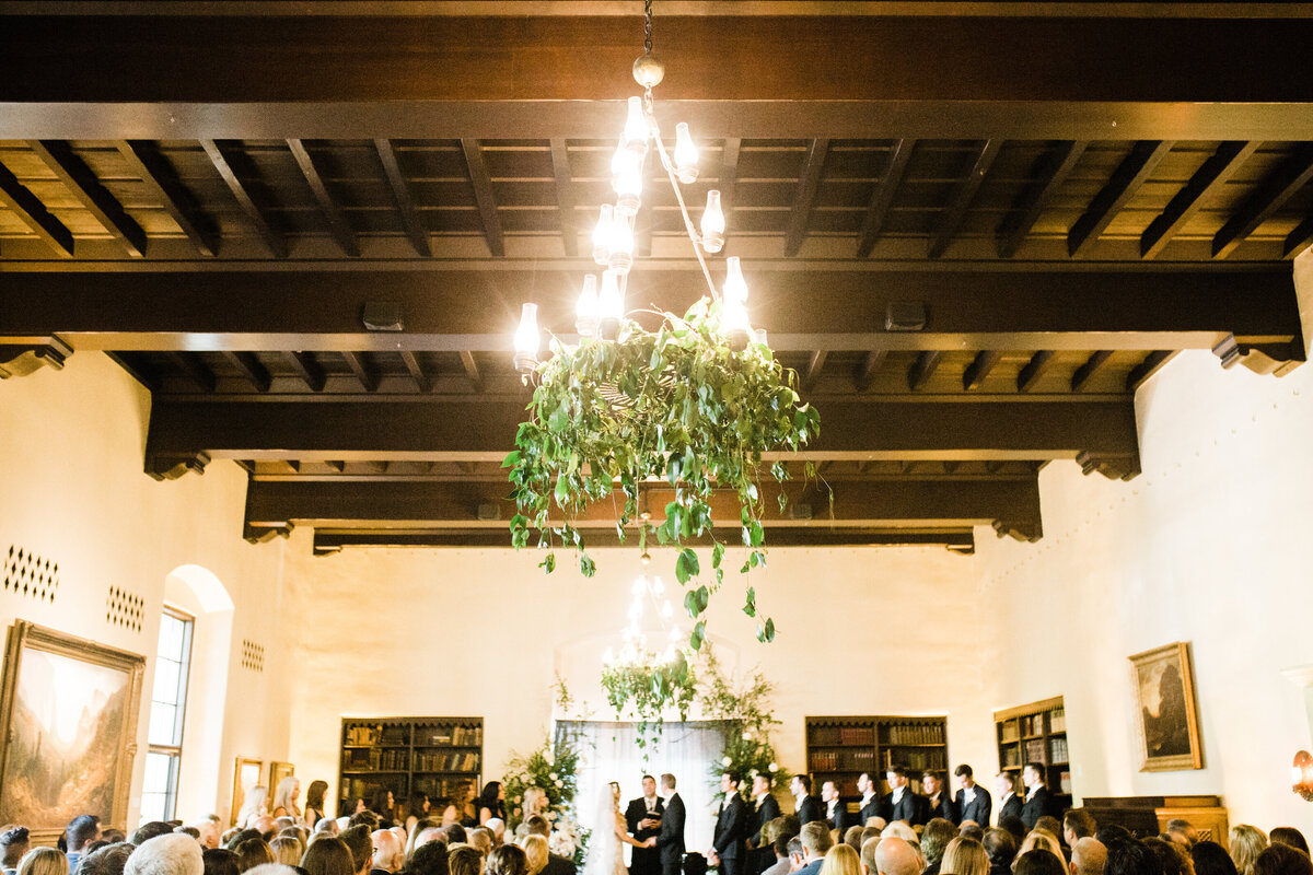 iron chandelier hanging with greenery