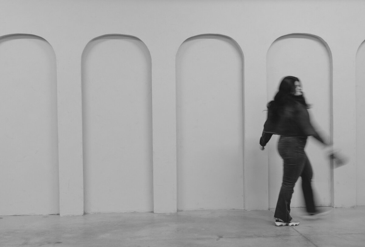 Blurry photo of Brigette walking away with her camera in hand