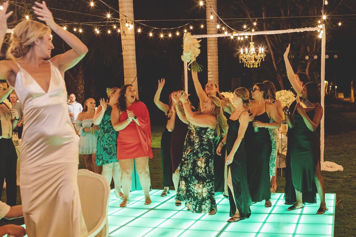 Bride tossing bouquet at  Iberostar Paraiso Riviera Maya Wedding