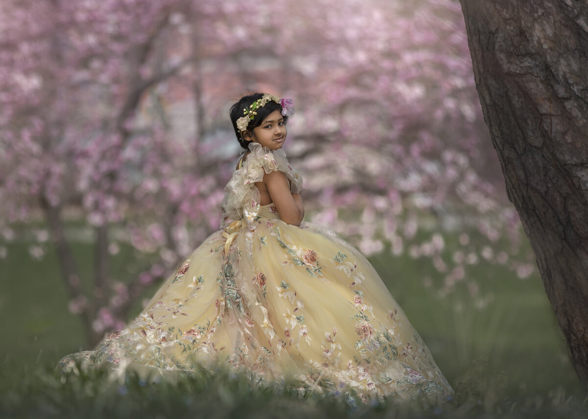 Girl in a fancy dress in the spring bloom during her outdoor photo session in Ottawa Ontario