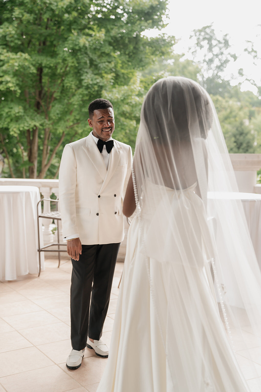 black couple wedding day in tux wedding dress veil