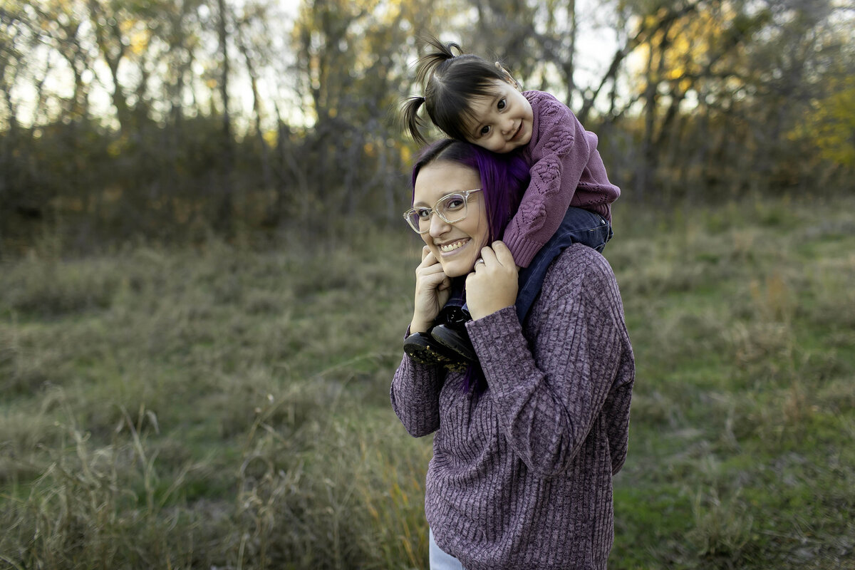 A picture-perfect family, laughing together and creating lasting memories during a playful photoshoot