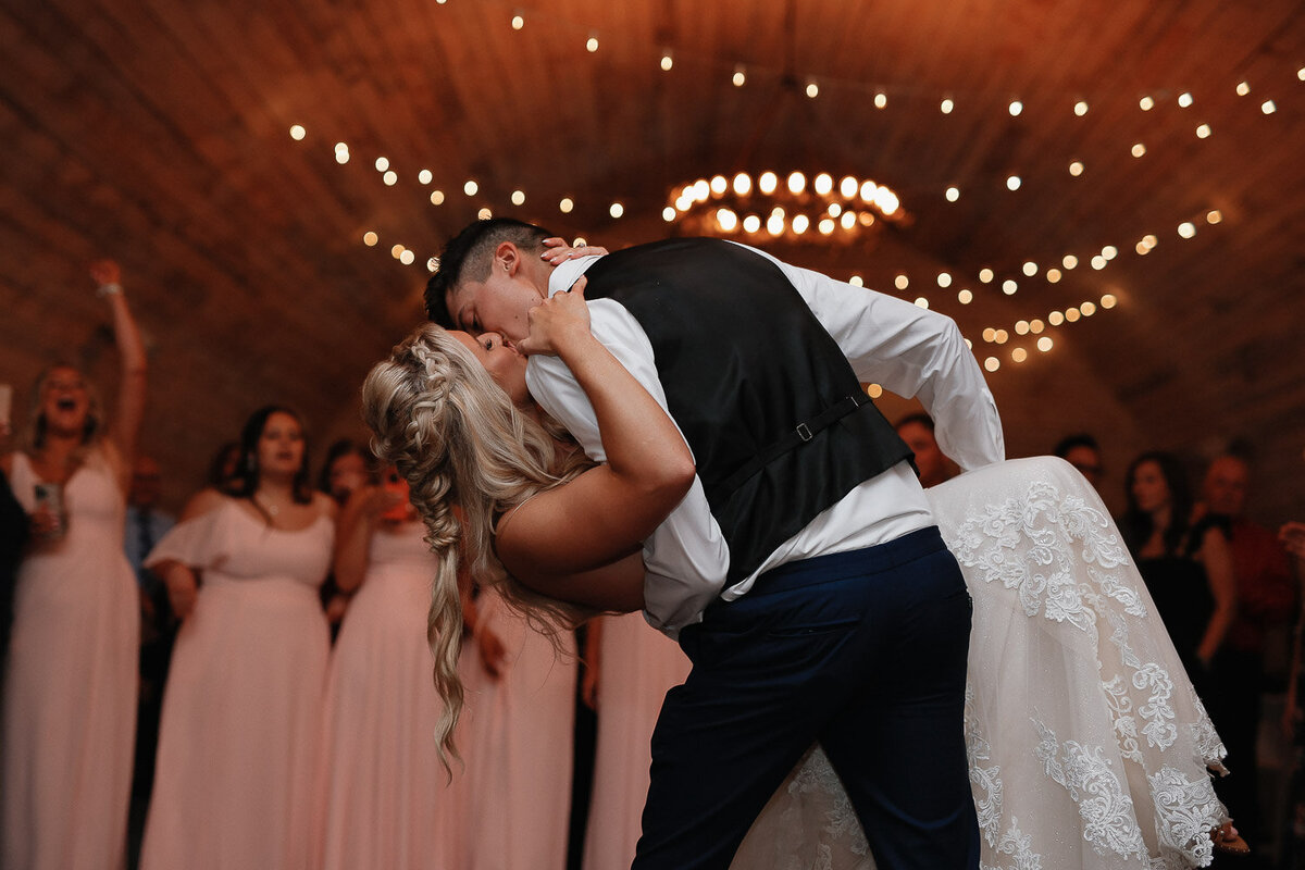 Bride and Groom dip kiss during reception 