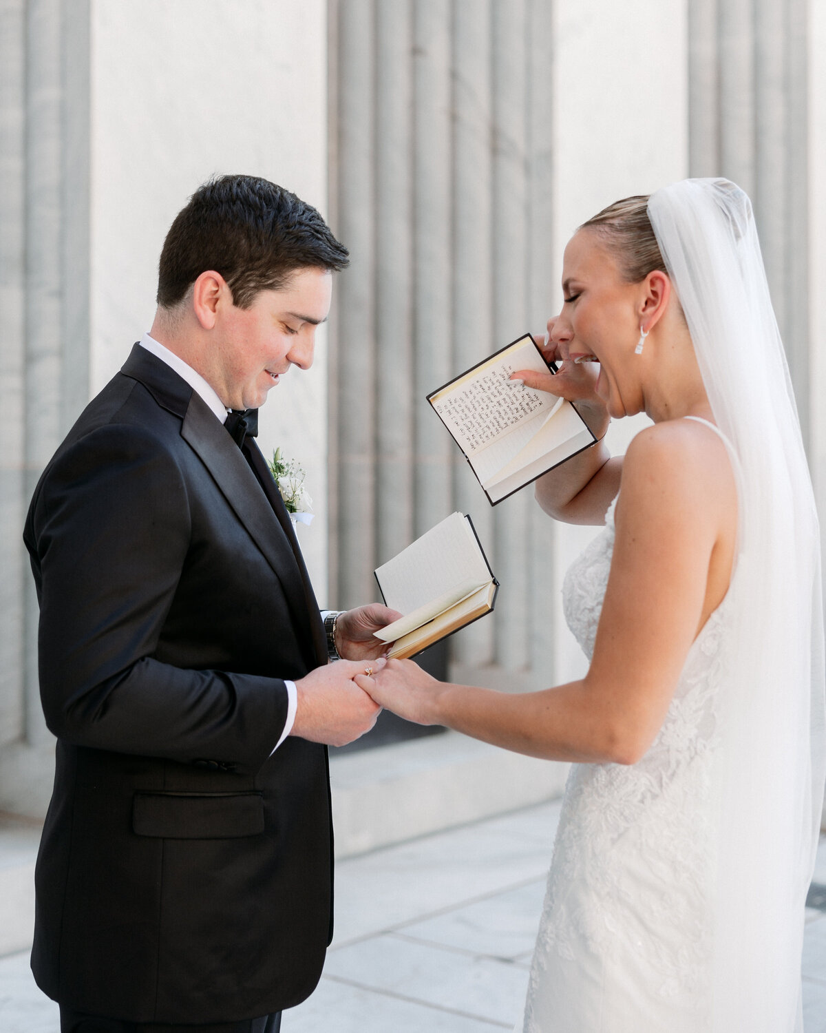 Bride wipes away happy tears while reading vows with groom, captured by a Philadelphia wedding photographer.