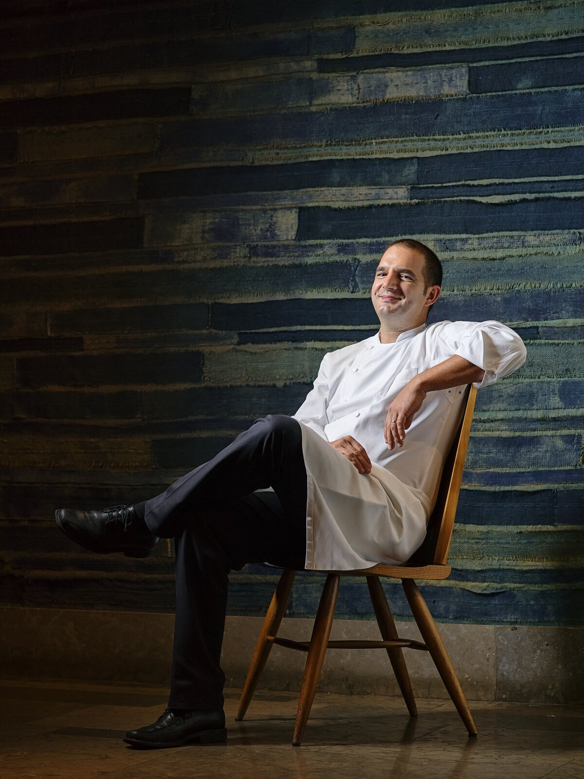 A chef leaning back relaxed in a chair