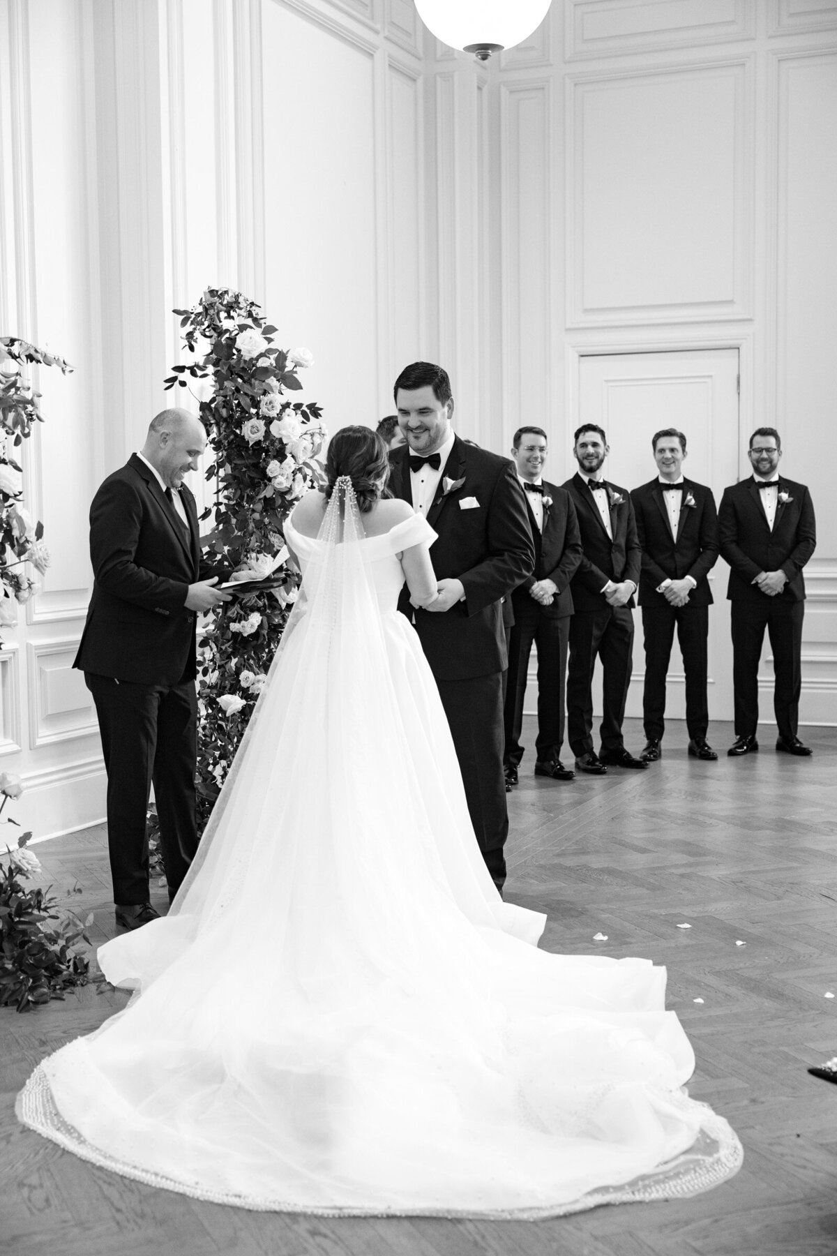 groom looking at the bride during their ceremony in the Governor’s Room at The Adolphus in Dallas, capturing a tender and intimate wedding moment.