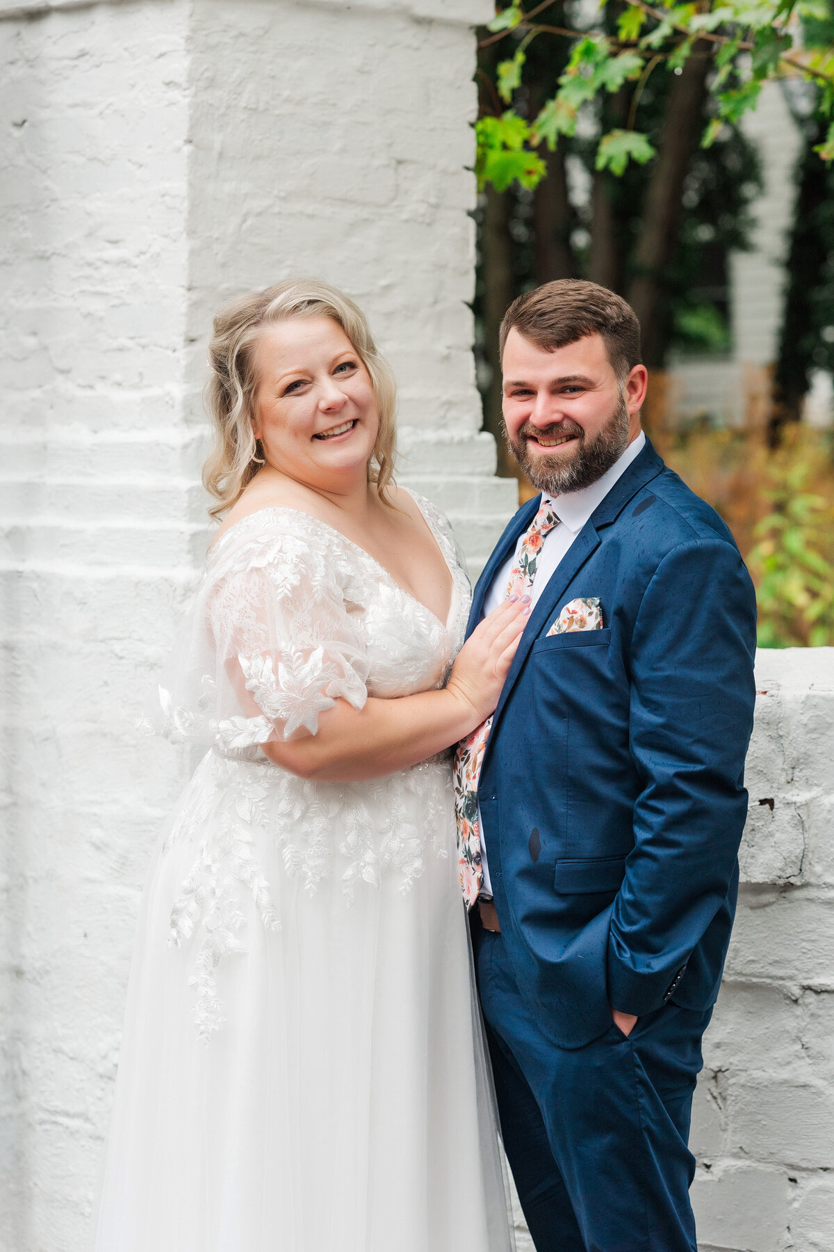 wedding couple smiling for a photo in front of the Hyeholde restaurant