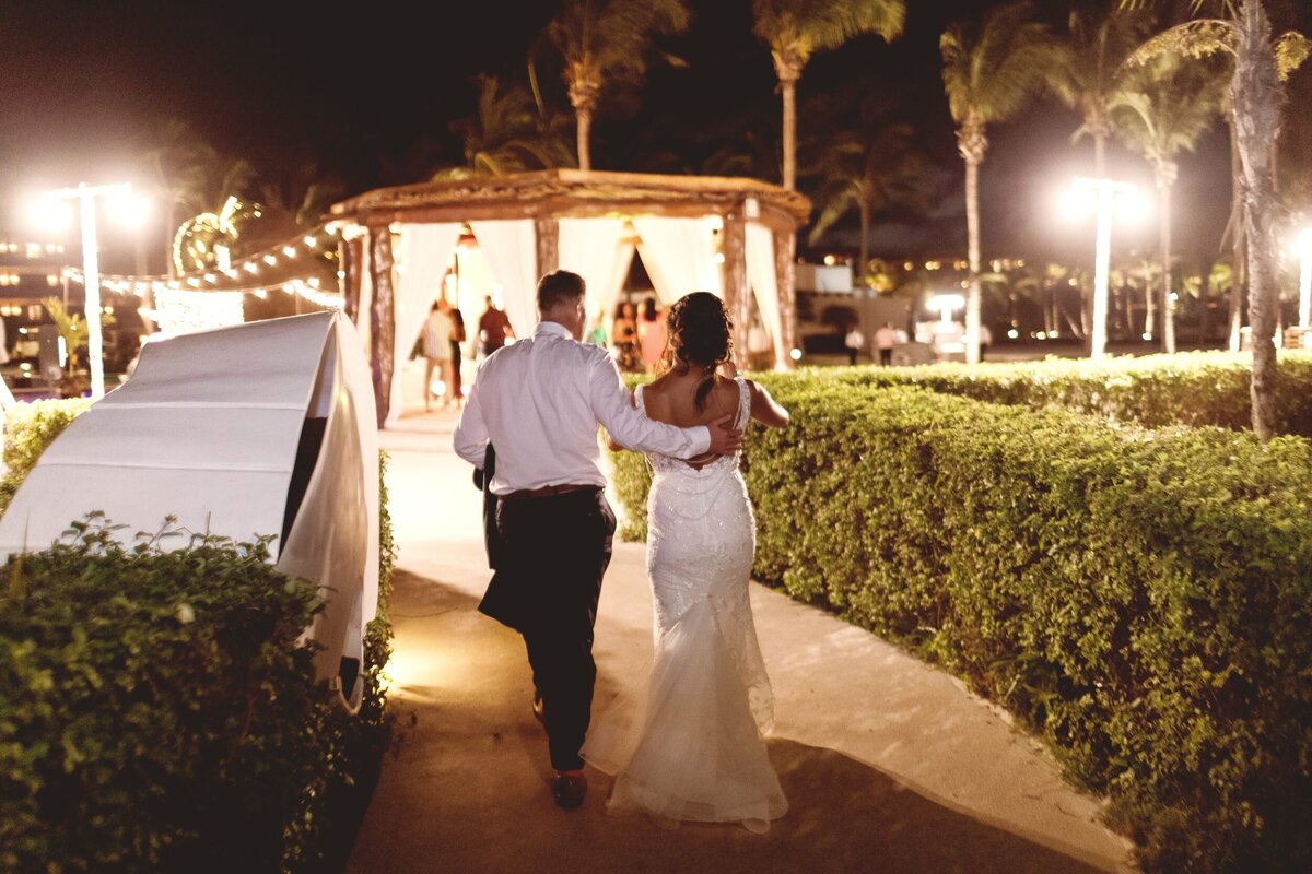 Bride and groom walking back to ceremony location at wedding in Riviera Maya