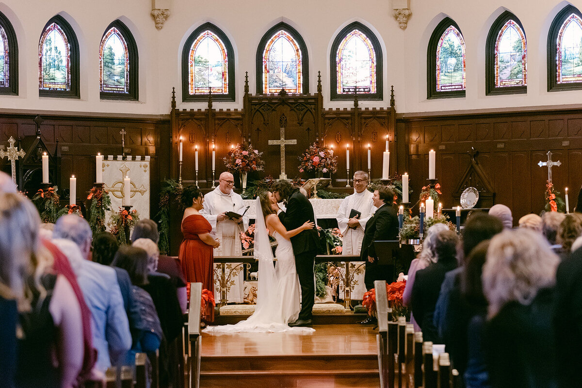 Bride and Groom Kiss at the Altar