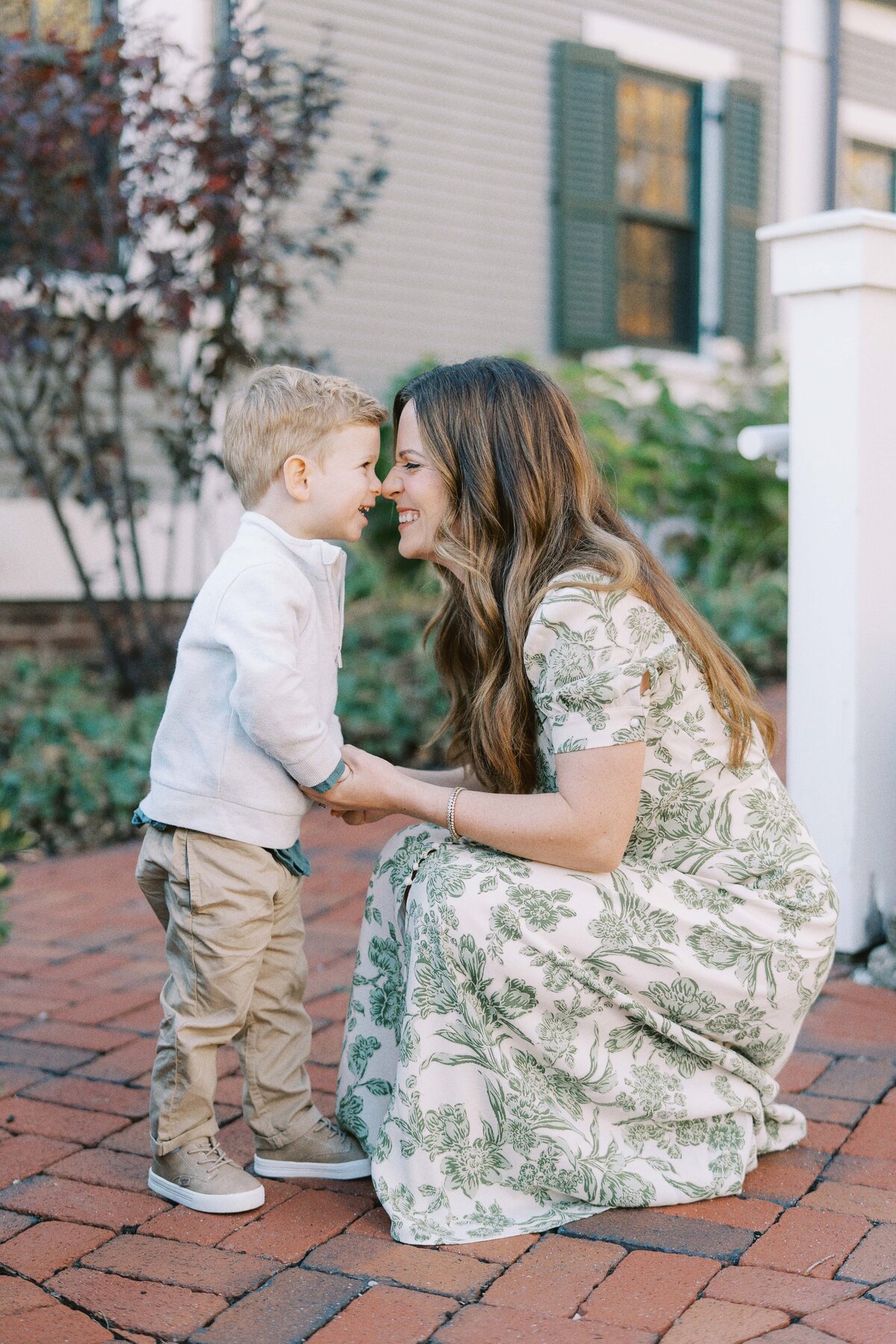 mom touching noses to toddler son