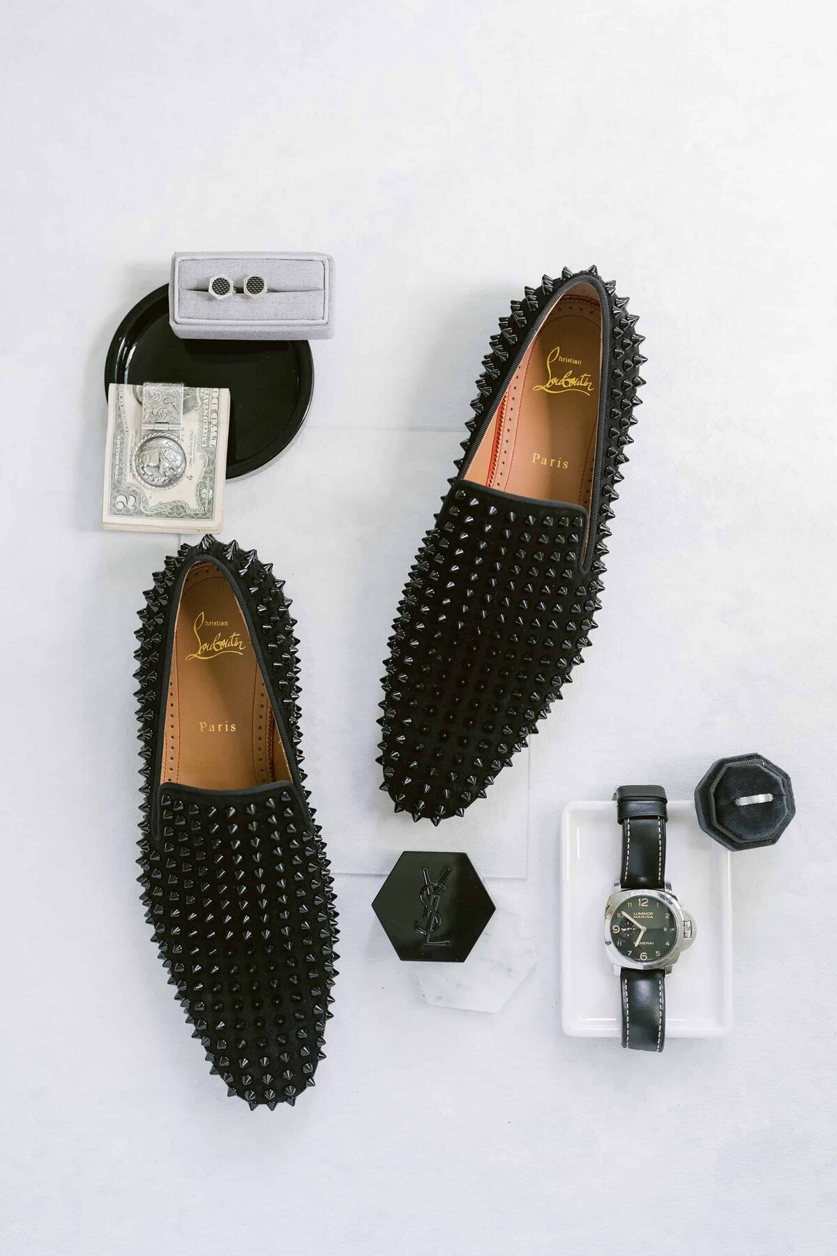 Groom's black studded shoes, watch, and cufflinks before the wedding
