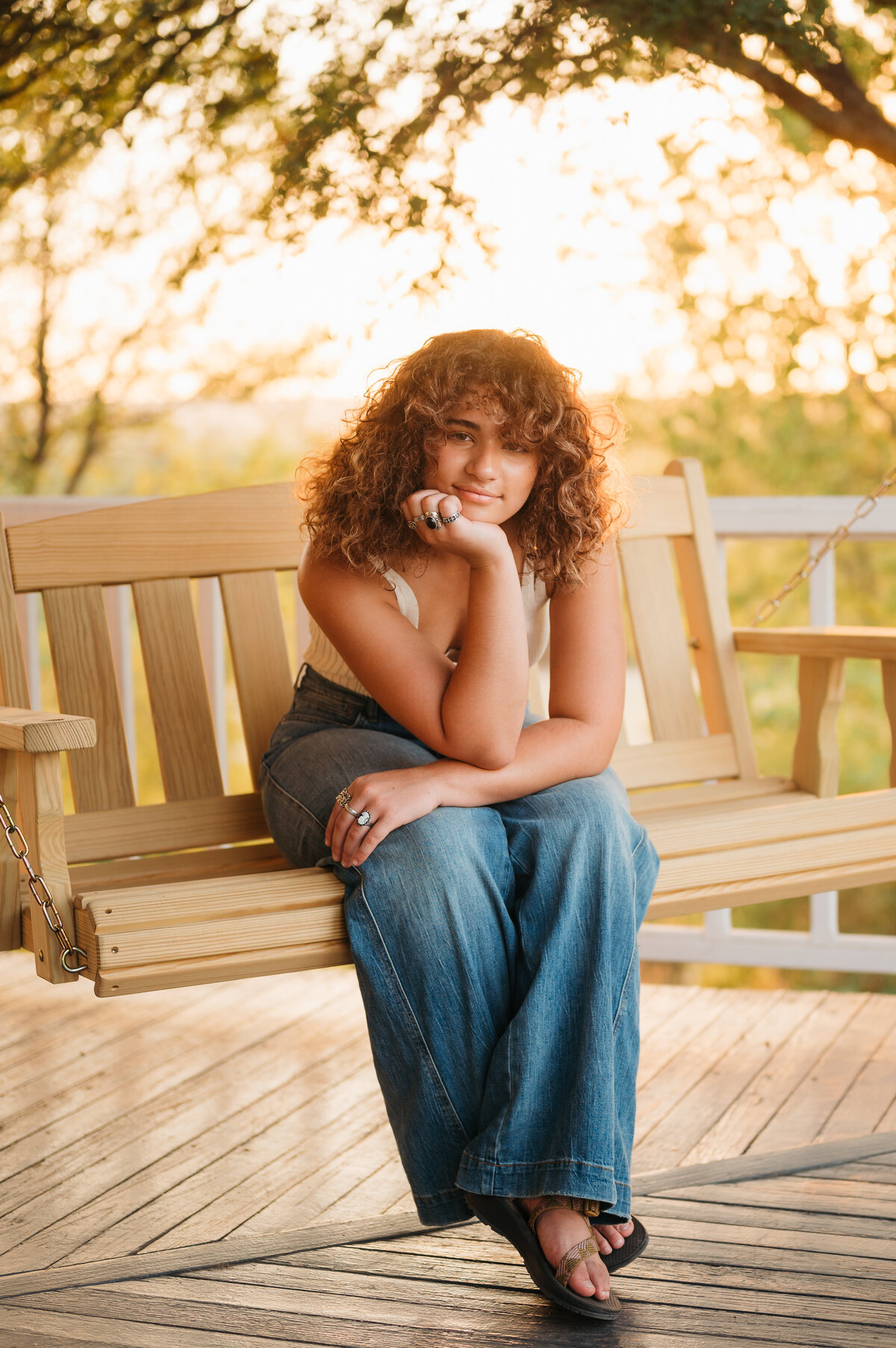 Senior girl sitting on a wooden bench at sunset — relaxed and authentic senior photography in Aledo by Poppy + Blue Photography