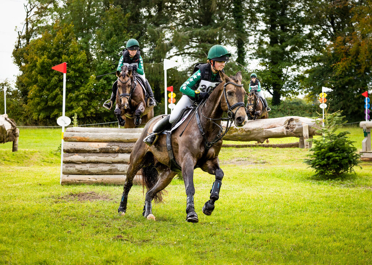composite of girl riding a dun horse cross country
