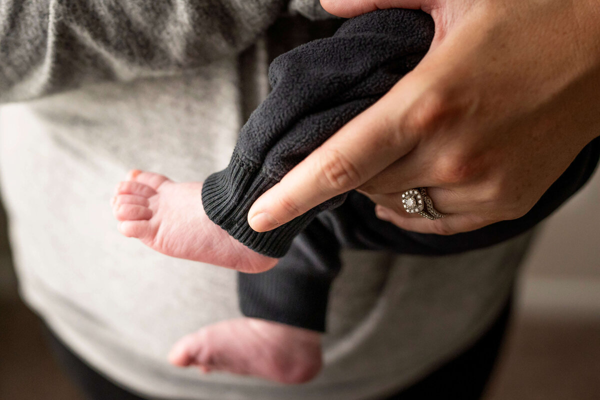 Close up of baby's feet and mother's hand