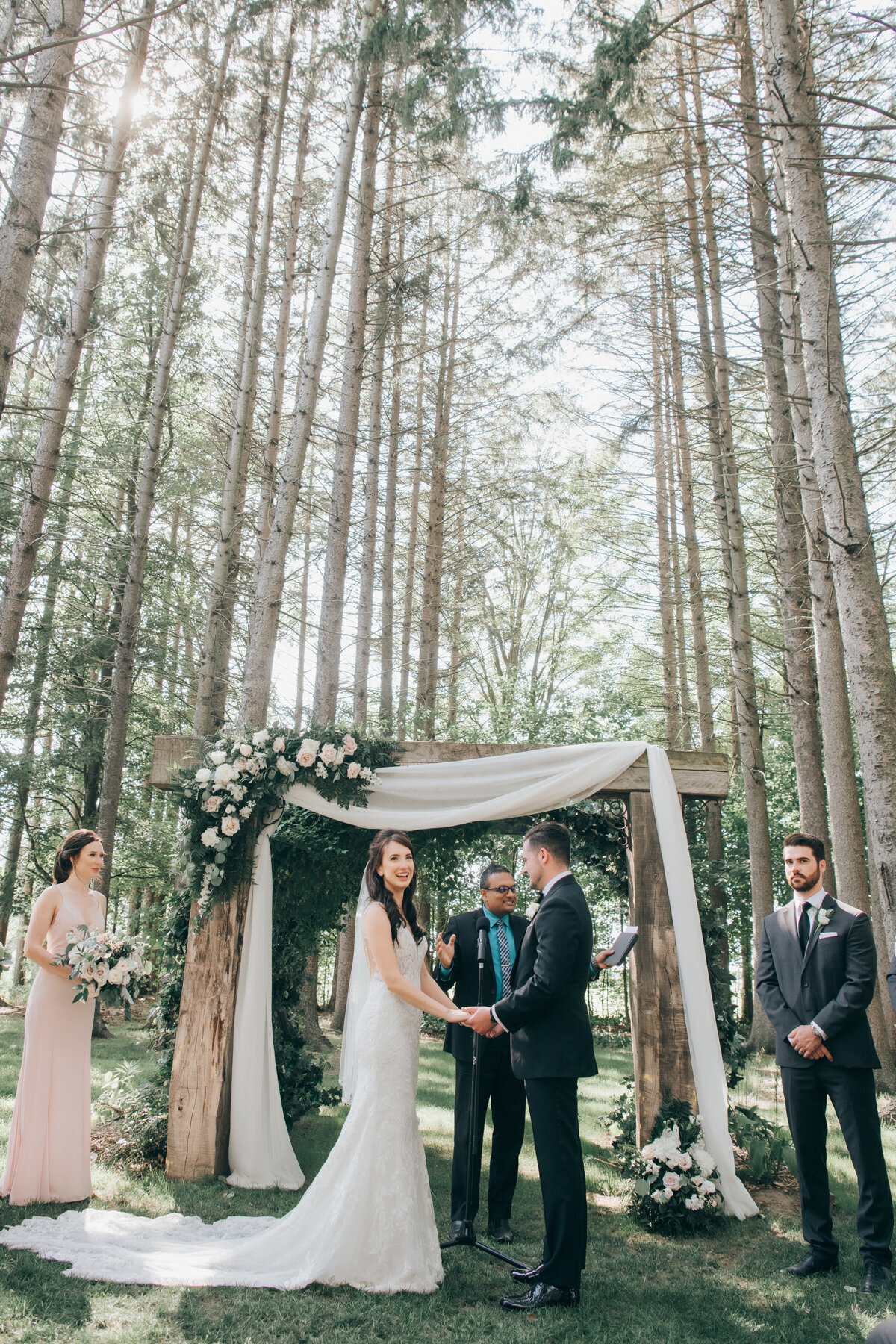 Bride and groom during their romantic forest wedding ceremony