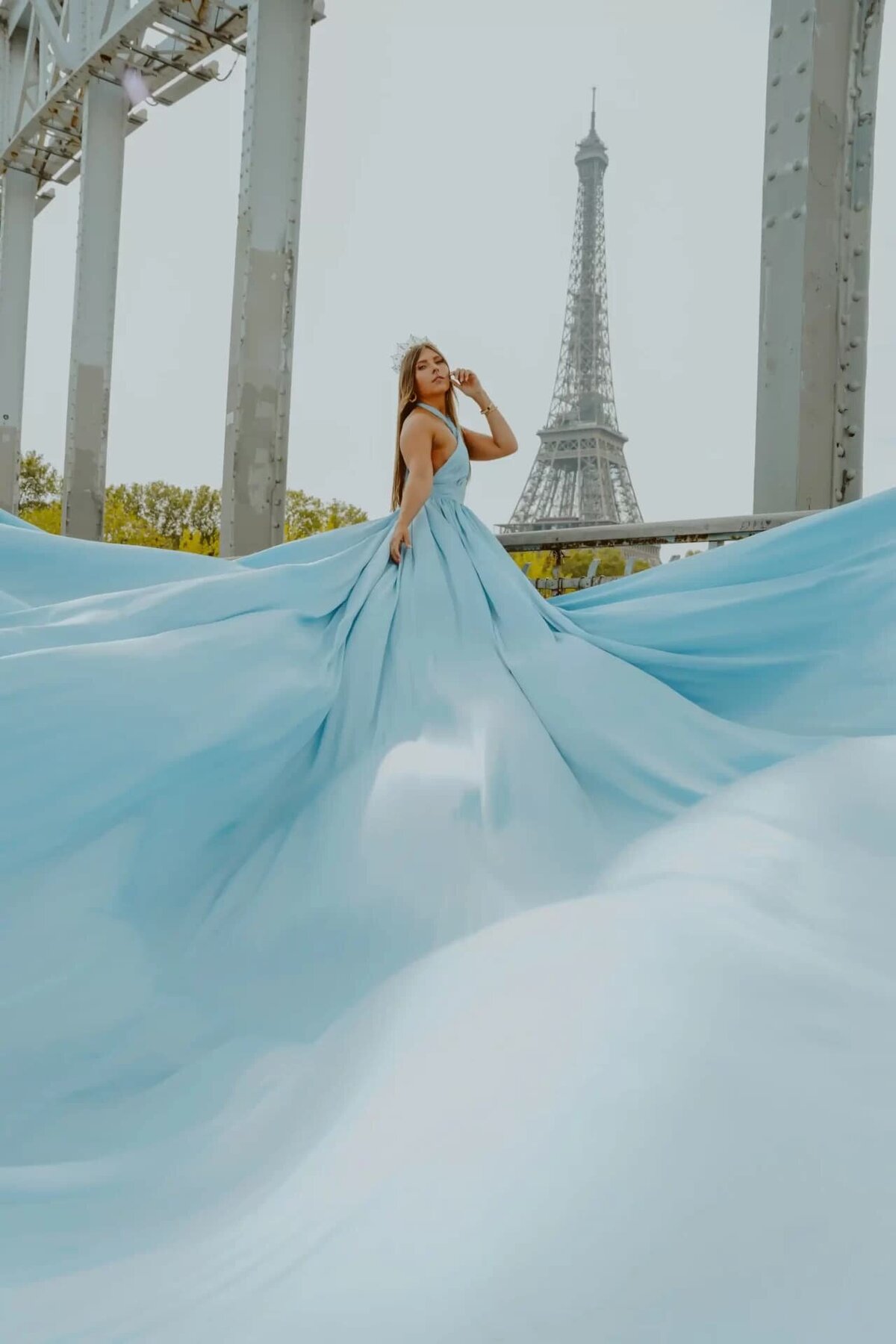 women having a portrait photoshoot in paris wearing a blue flying dress