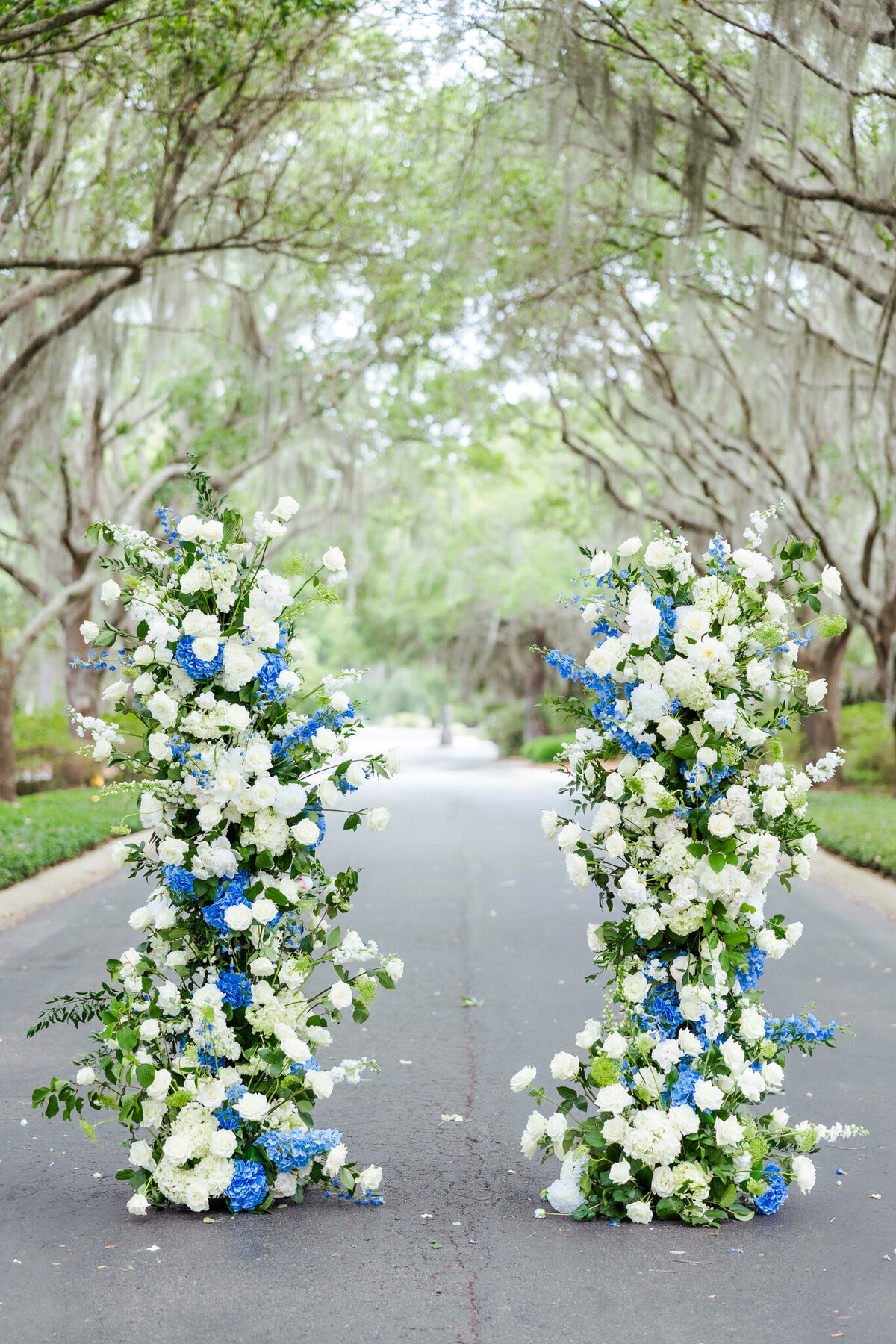 pillars decorated with blue and white hydrangeas