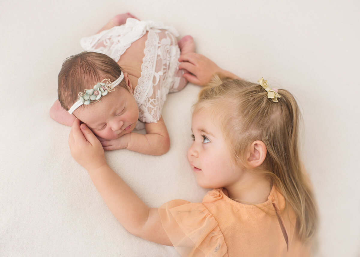 sibling girl with newborn