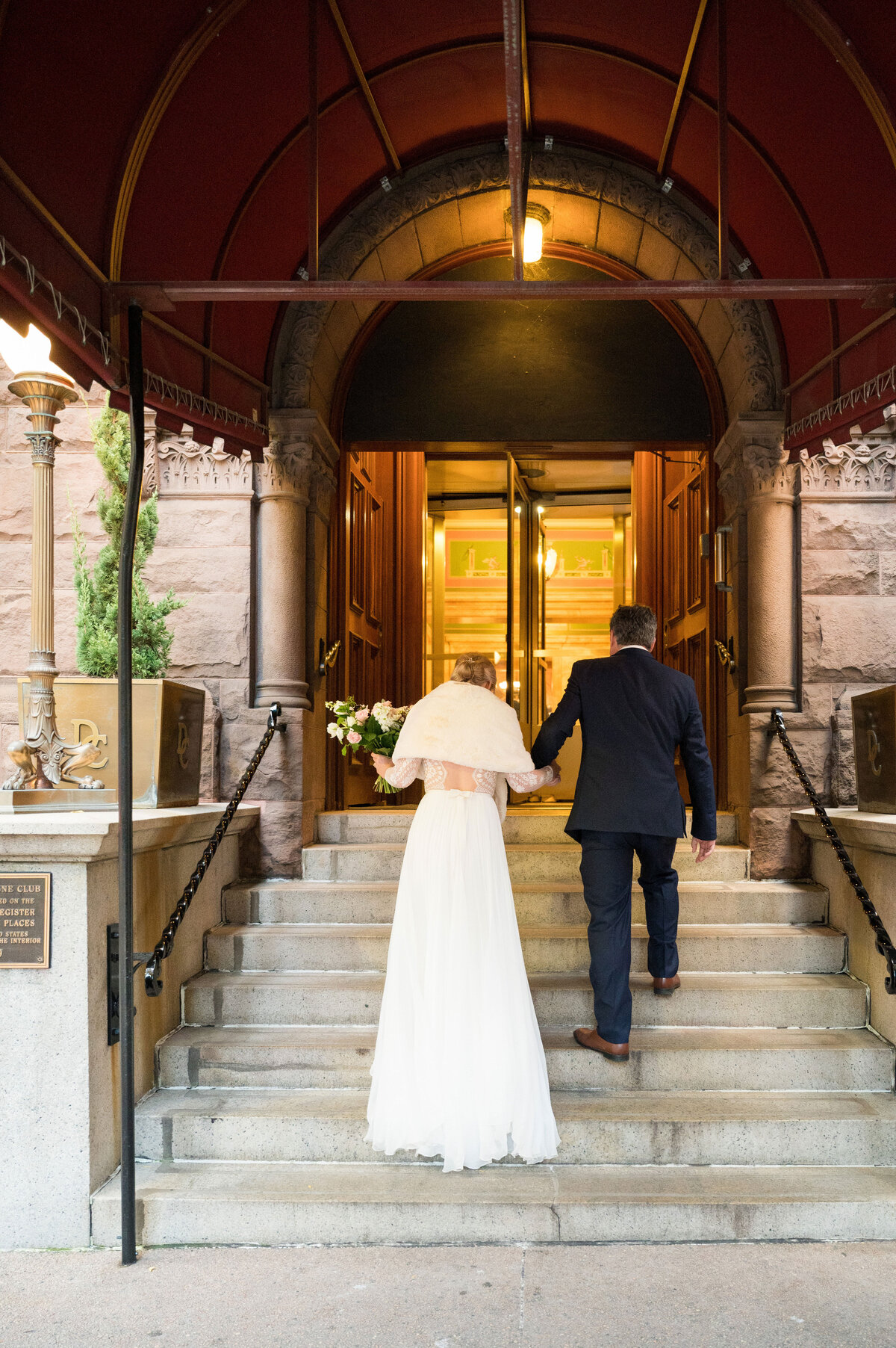 wedding couple walking into their duquesne club reception venue