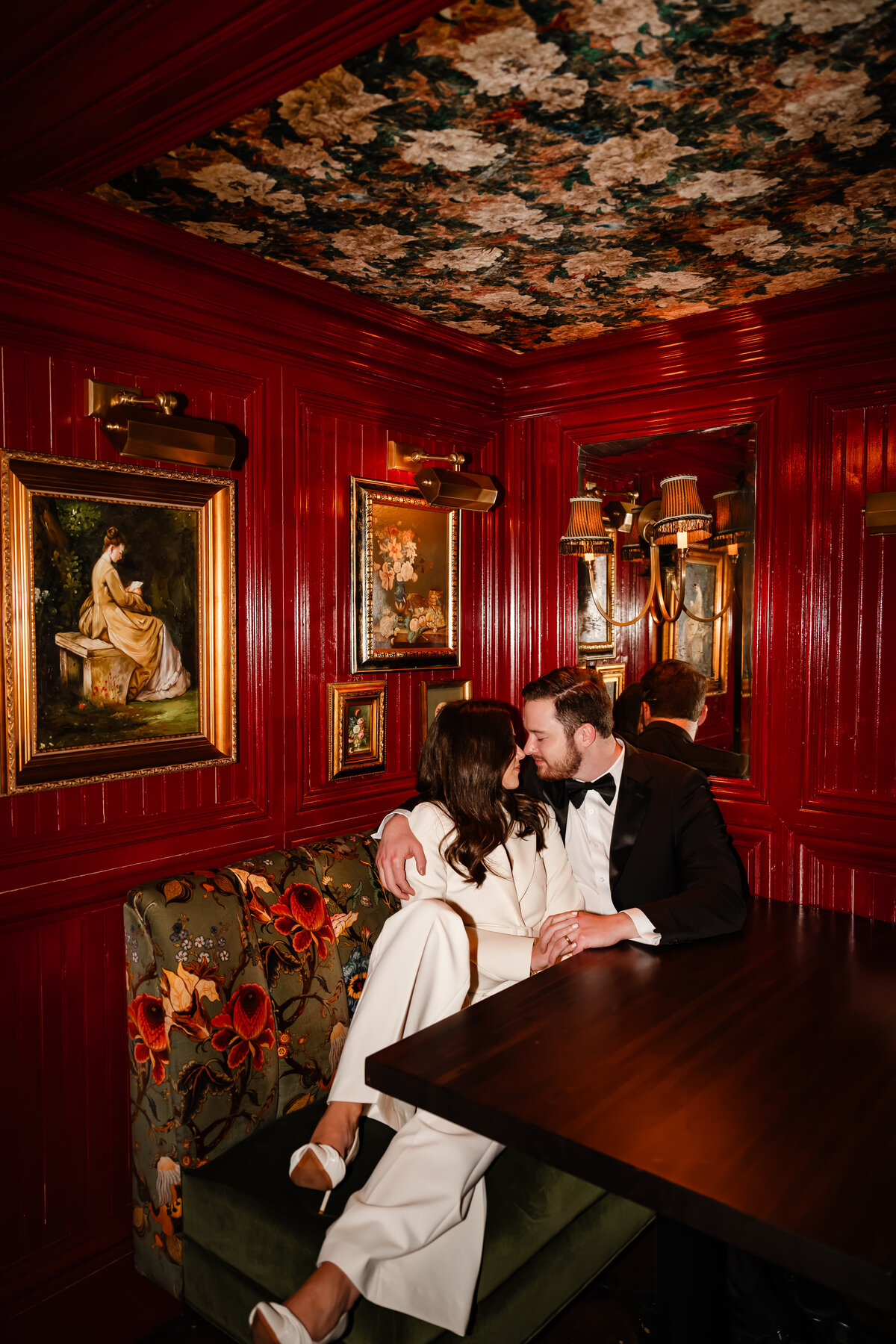 A couple kiss in a booth at Gilt Bar in Chicago, IL.