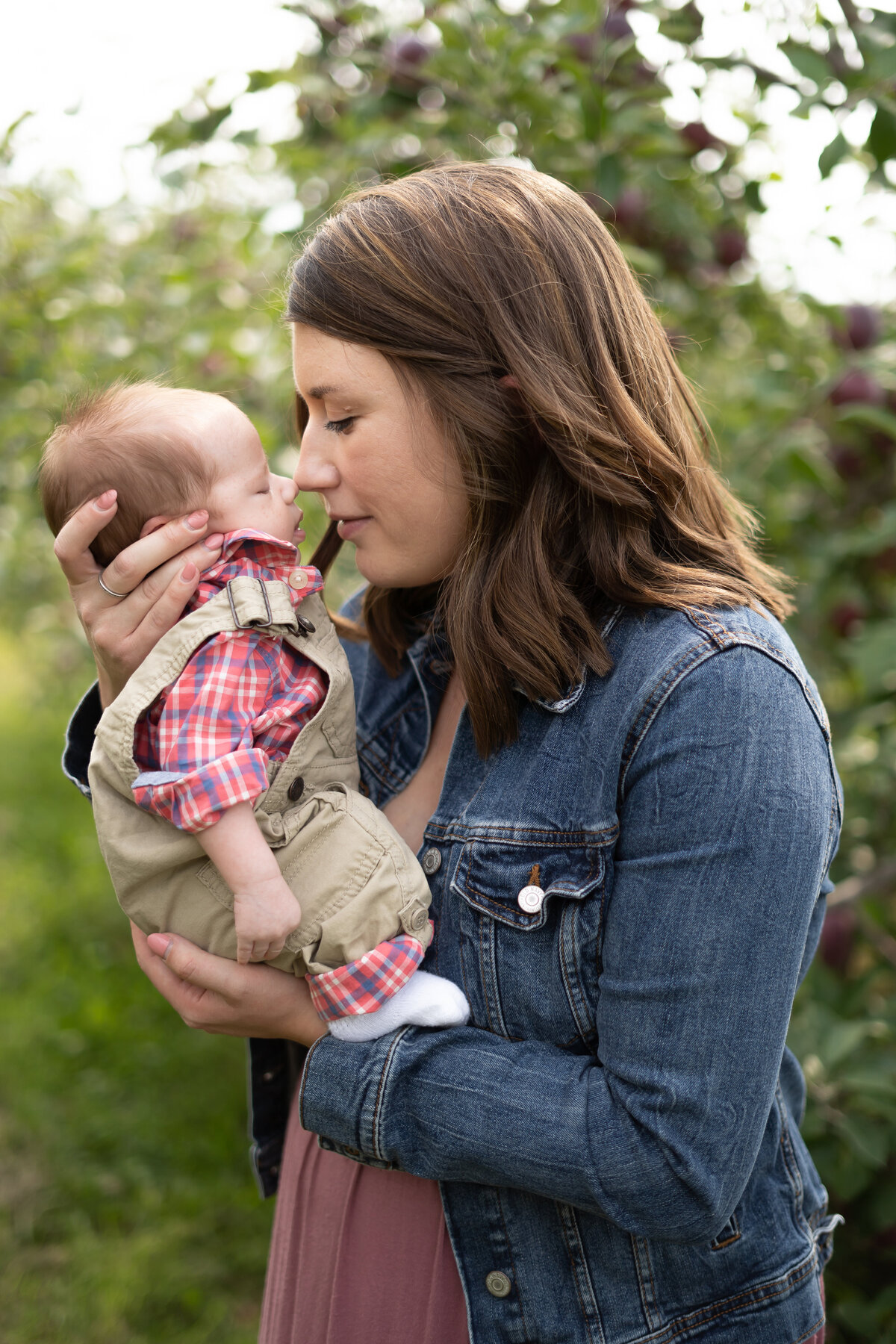 mother nose to nose with baby boy apple orchard fall family session northeast Ohio
