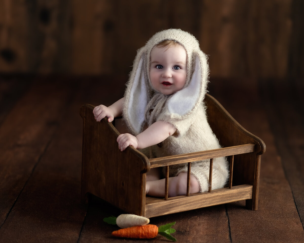 Milestone baby portrait in Paris, Ontario – featuring a sweet bunny bonnet and rustic styling that highlights the magic of childhood.