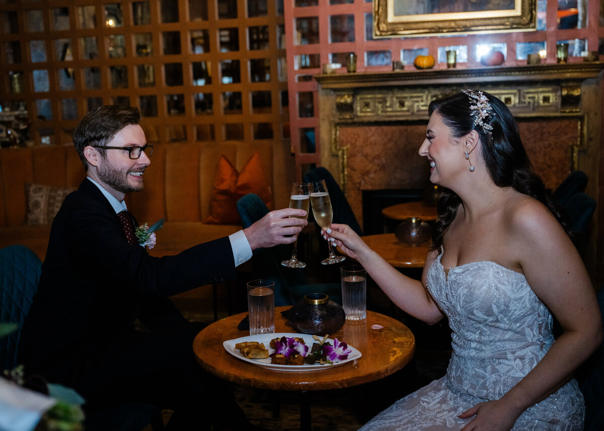 groom and bride toast at indoor wedding reception