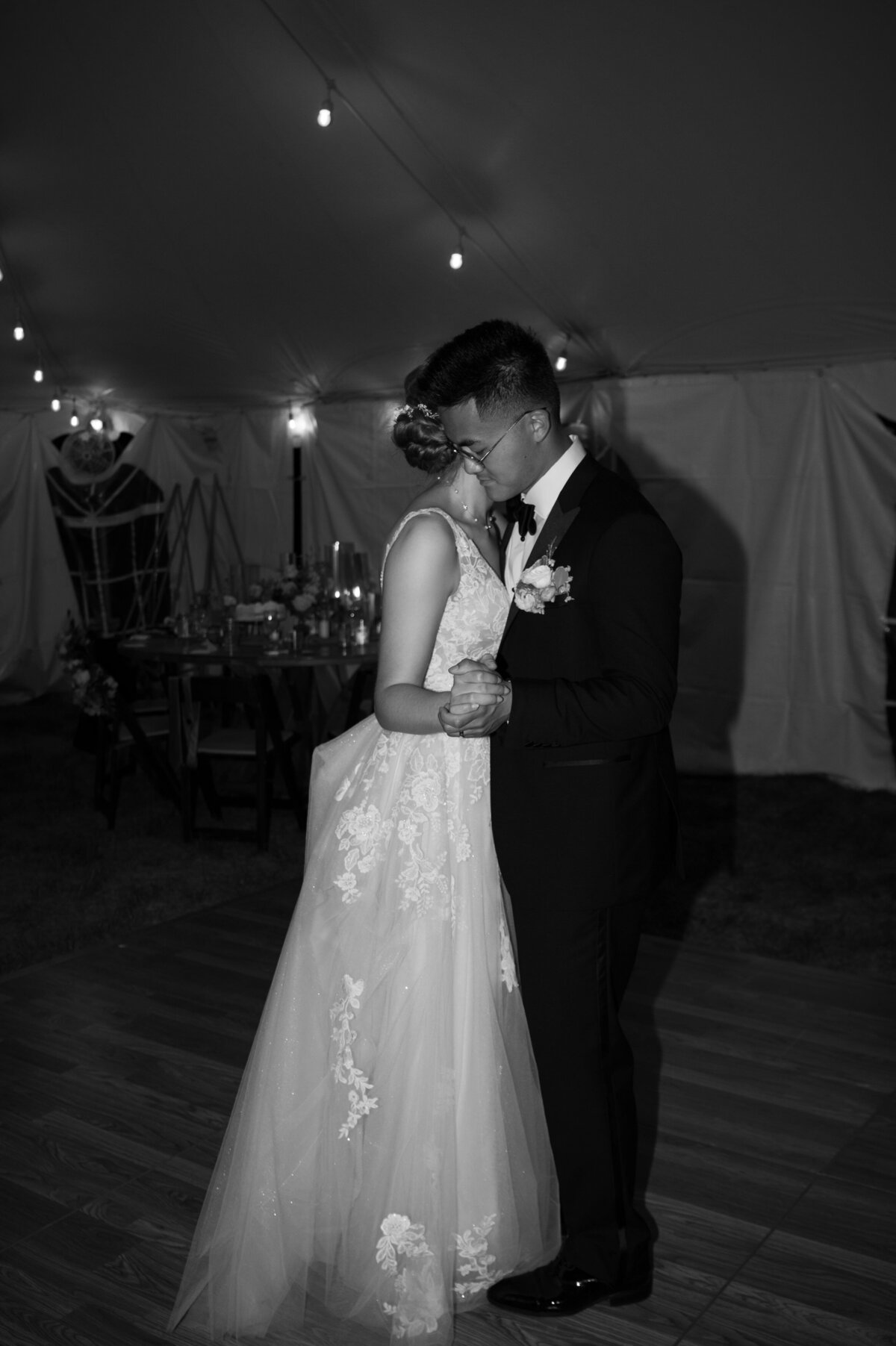 A newlywed couple dancing closely together