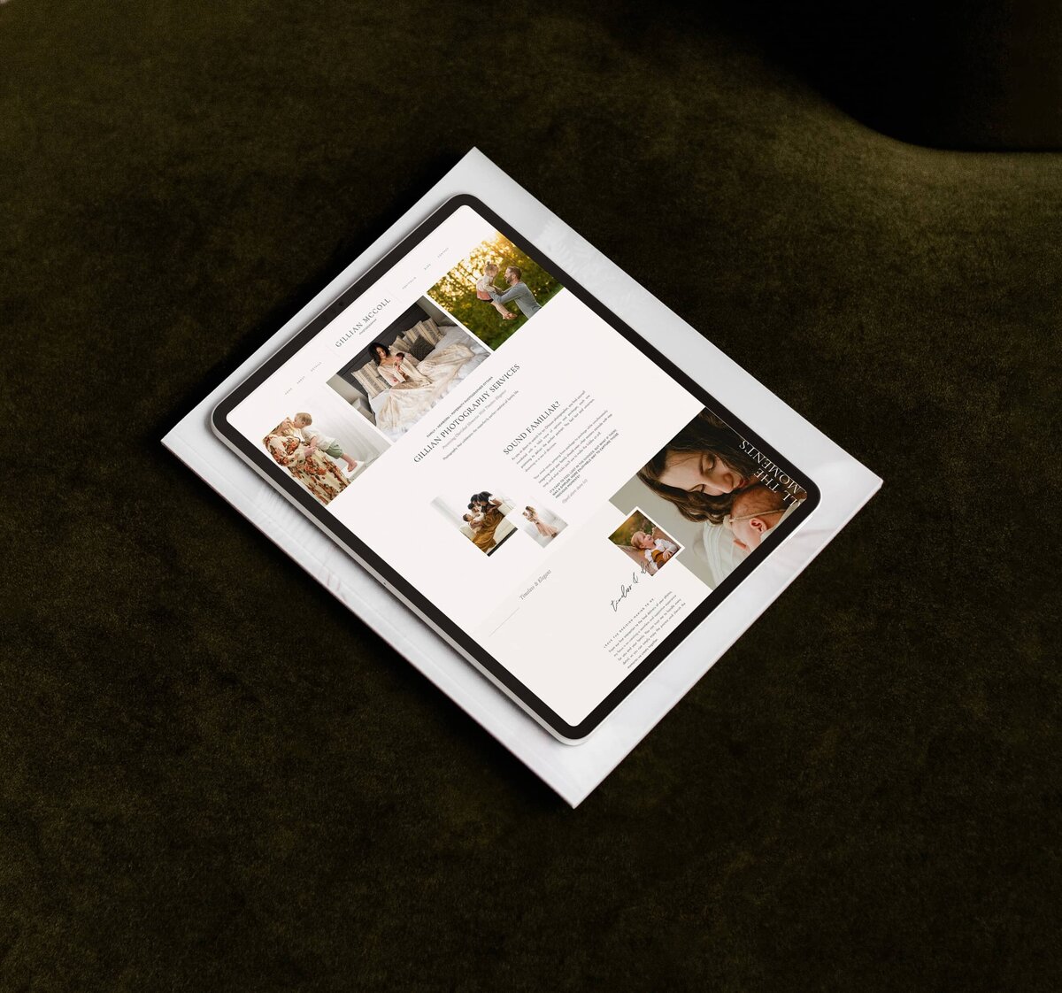 A tablet displaying a digital magazine lies on top of a folded paper on a dark green fabric surface. The magazine, featuring images and articles related to parenting and child care, showcases the elegance of showit web design for luxury photographers.