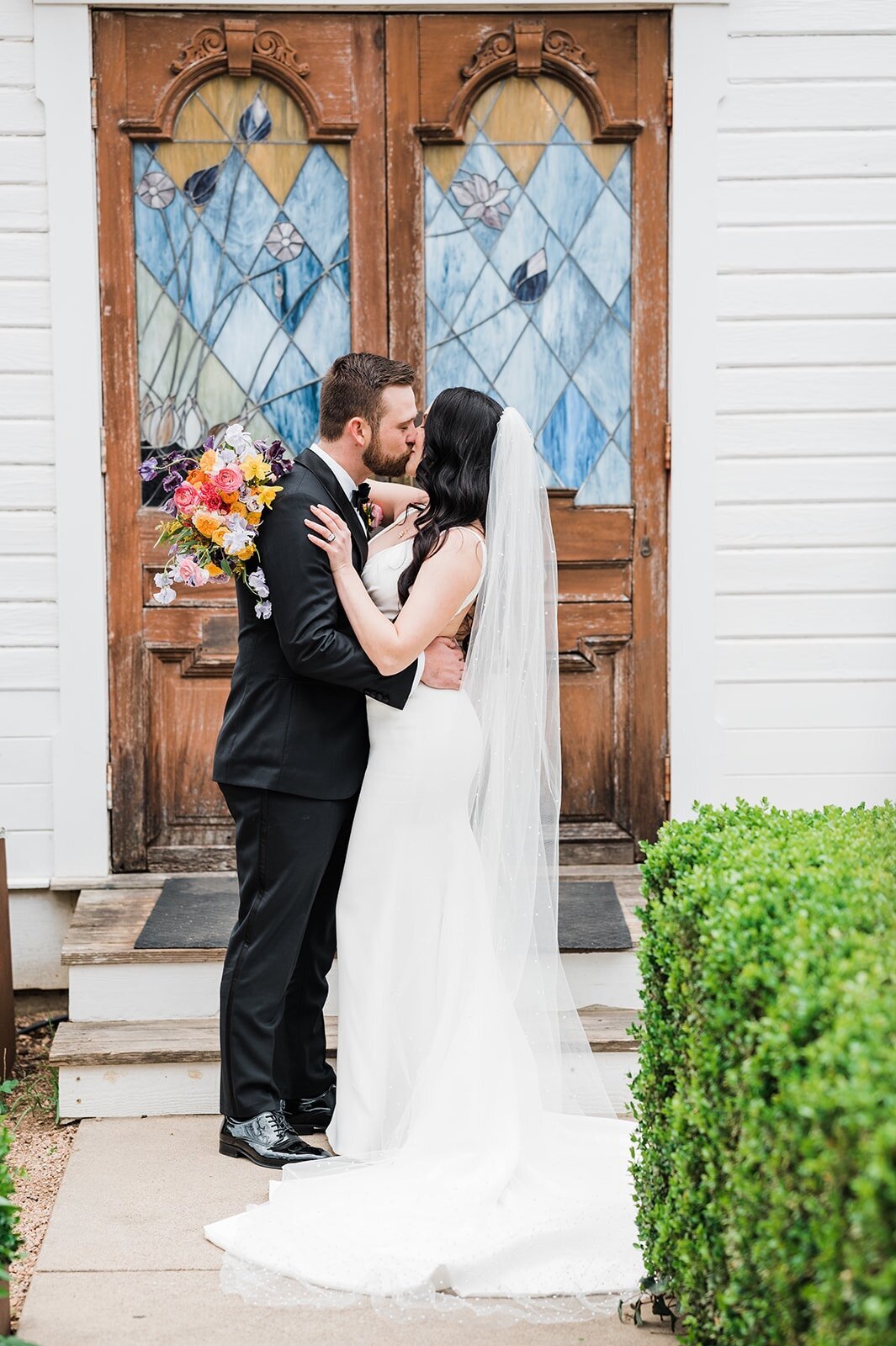 bride-groom-in-front-of-barr-mansion-stained-glass-windows