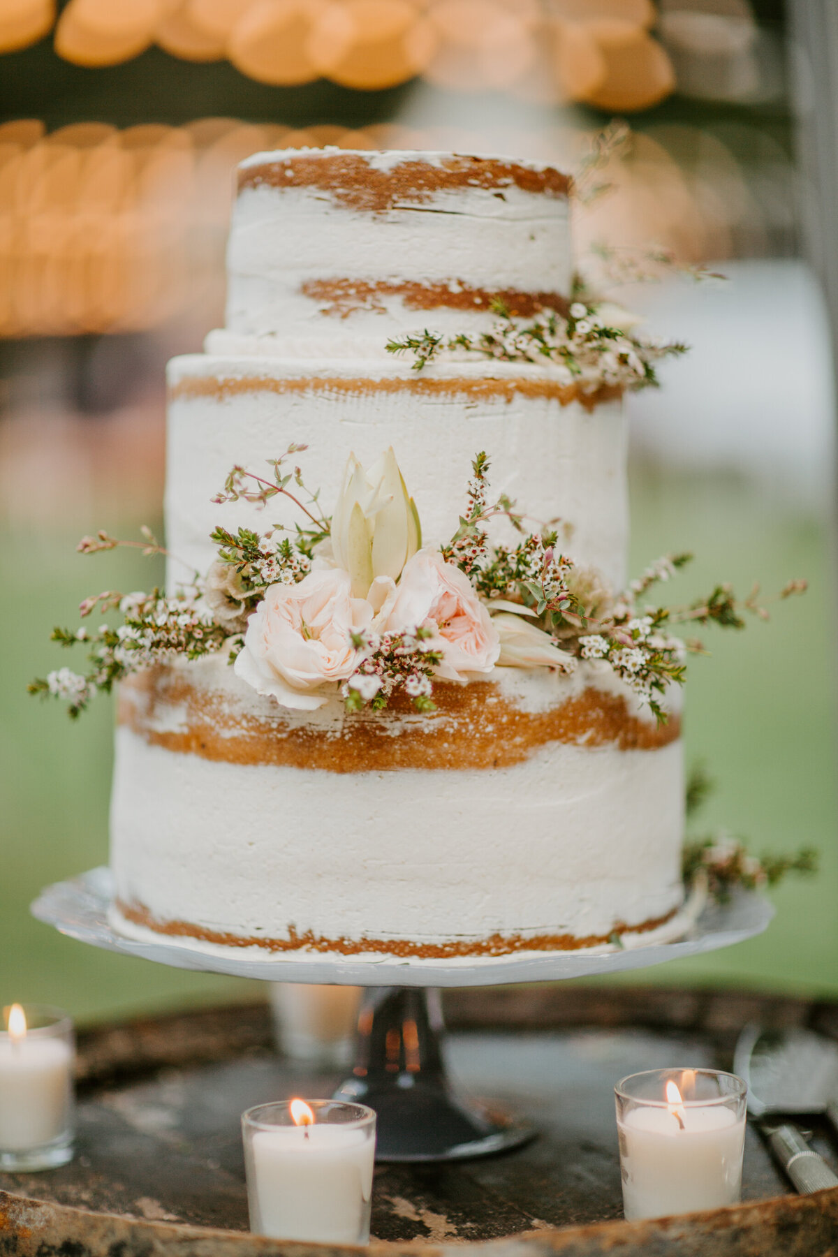 Rustic naked cake at glamping themed wedding