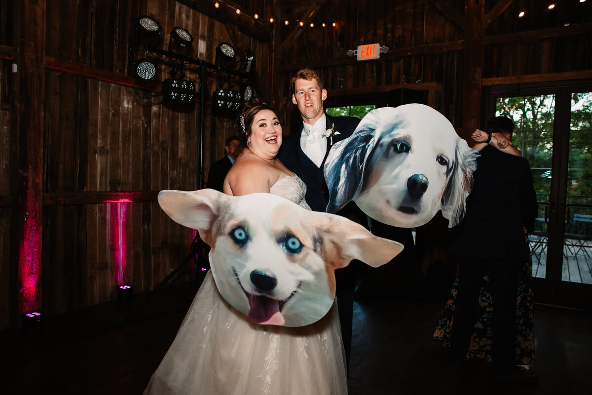 Newlyweds play with cardboard cutouts of their puppies