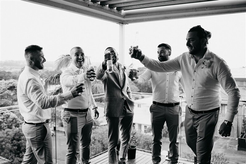 Matt and his groomsmen are having fun while fixing their wedding outfit