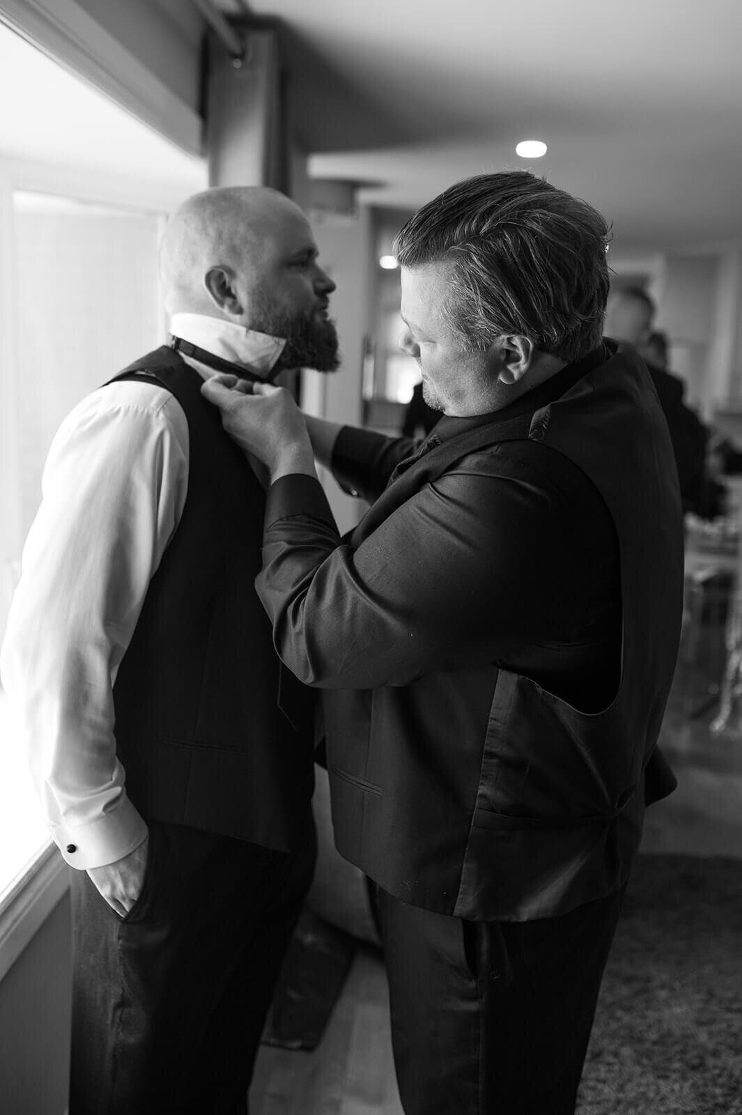 Man-helping-groom-with-bow-tie
