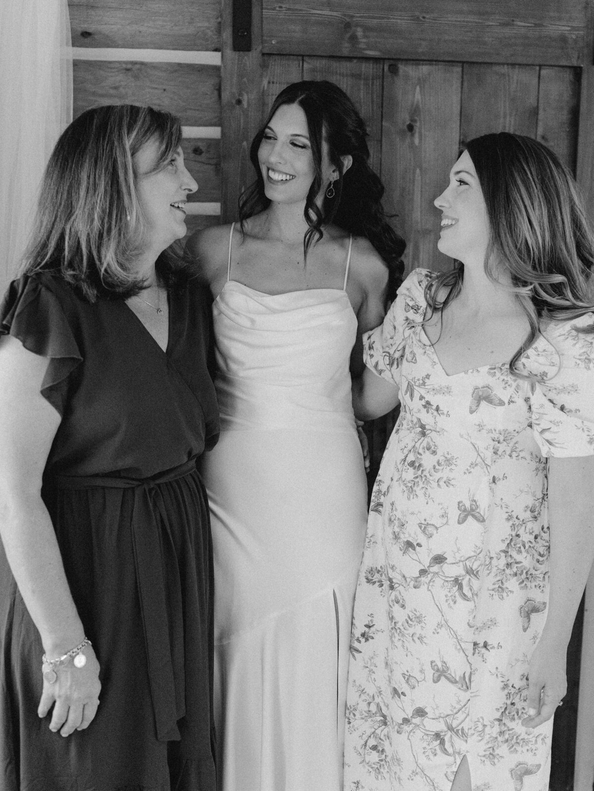 Bride with two women smiling at Dallenbach Ranch Colorado Wedding