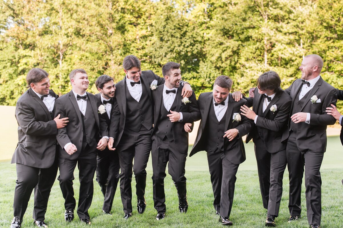 groomemen on golf course black tuxedos
