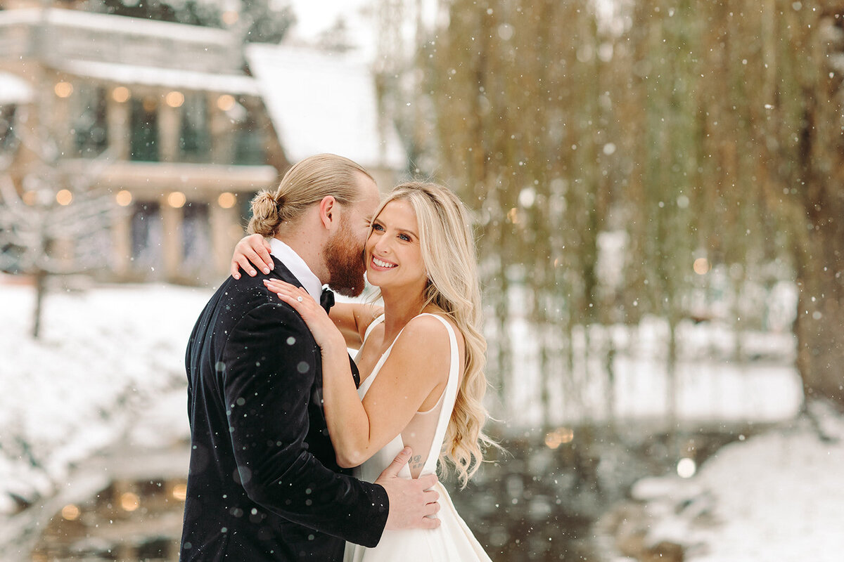 Utah Wedding Photographers capture bride and groom embracing during winter wedding in Park City