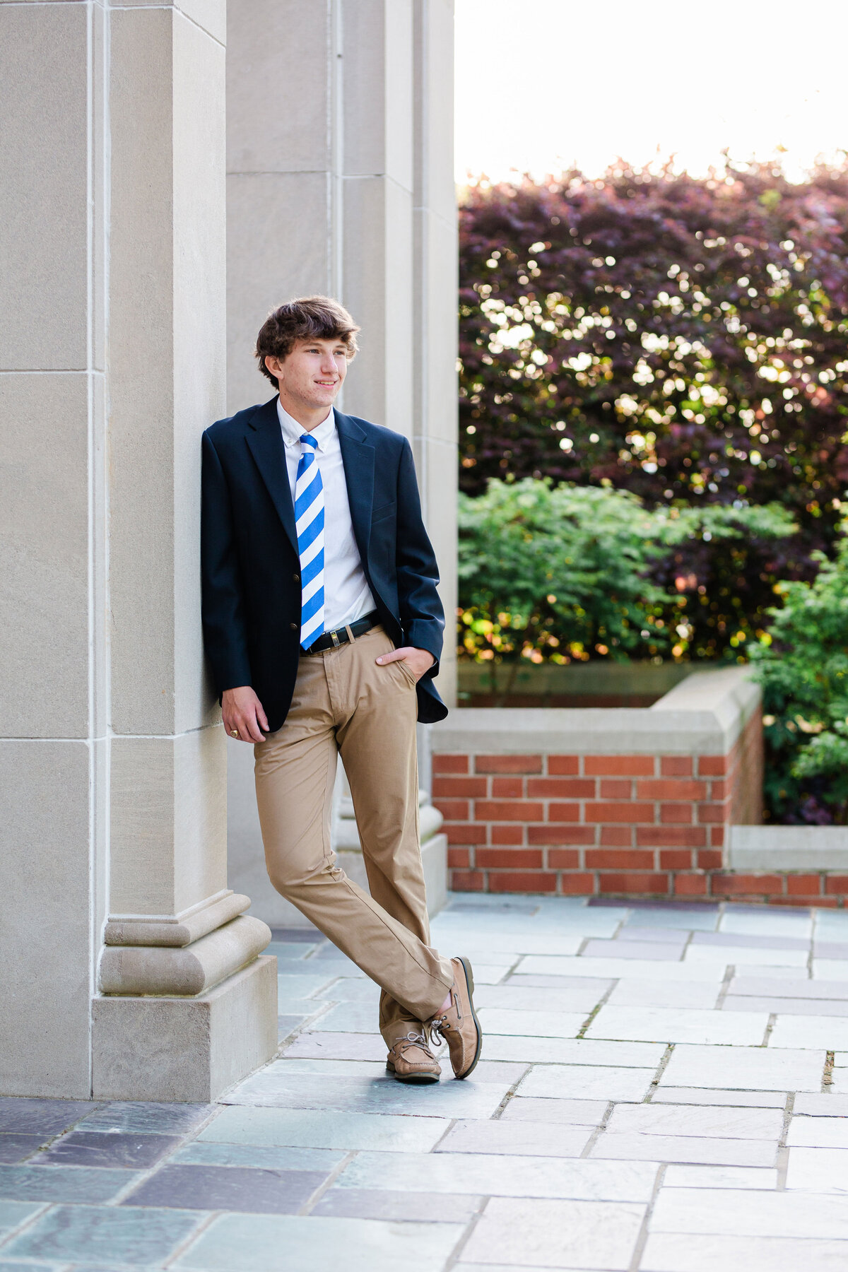McCallie School senior leaning against the columns at the chapel