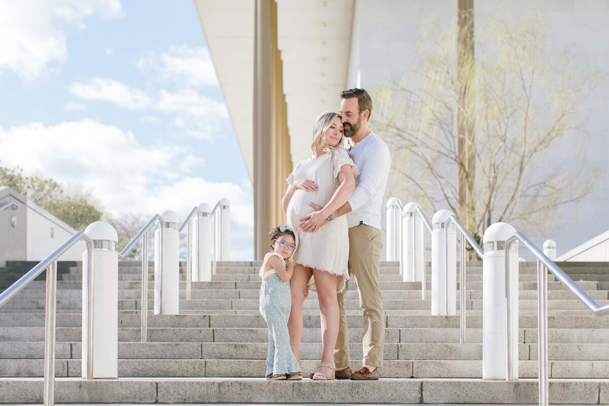 Pregnant mother with toddler  toddler daughter and husband on steps of Kennedy Center