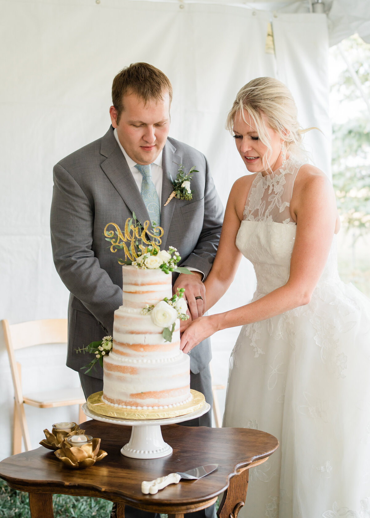 Cutting into cake during colorado springs wedding reception