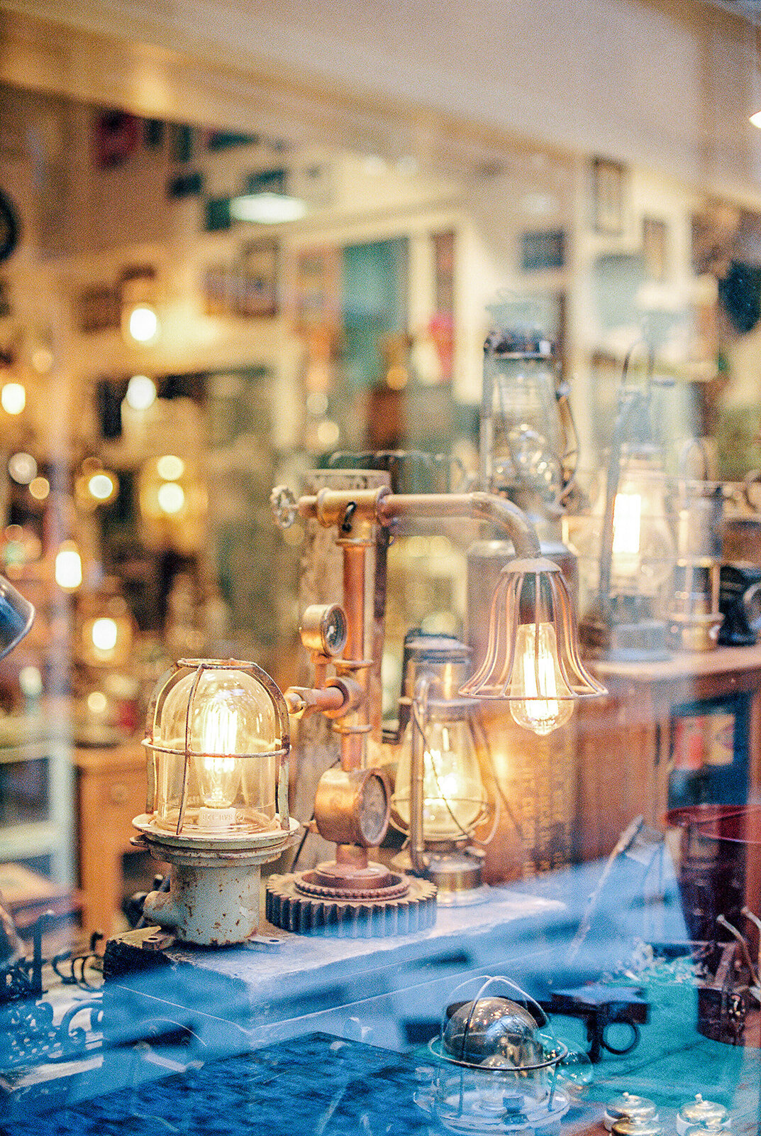 Film photograph of vintage lamps in an antique shop window in Paris France photographed by Fine Art Film Photographer