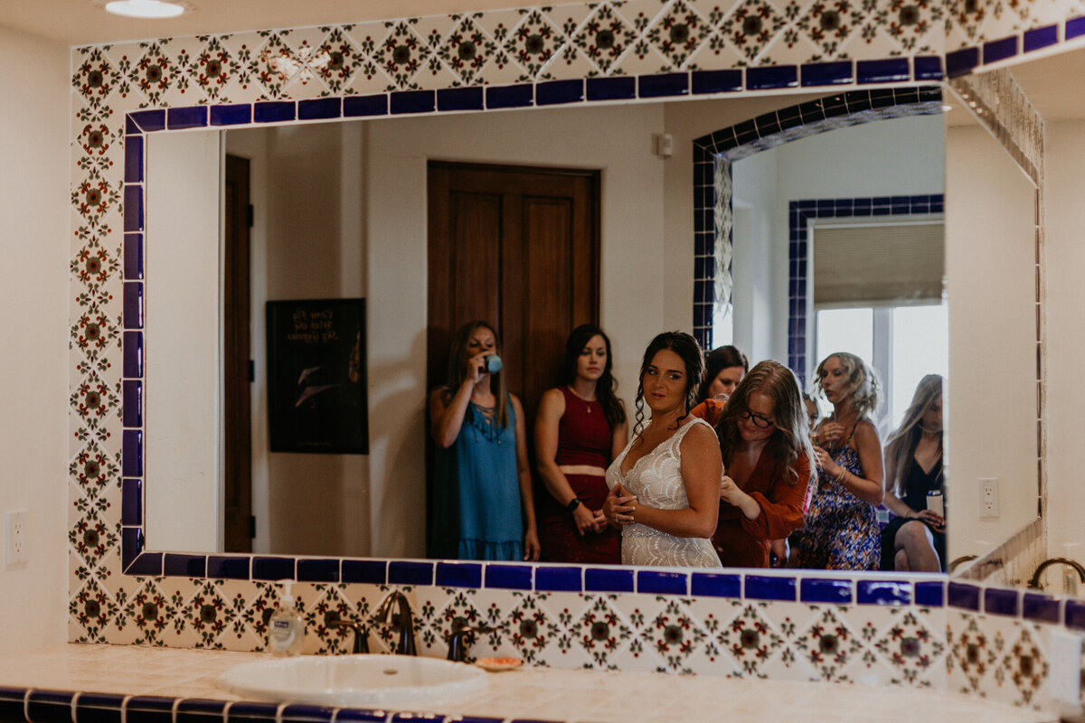 bride getting ready with her girls in a mosaic styled bathroom